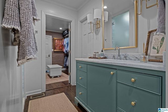 bathroom featuring ornamental molding, visible vents, wood finished floors, and vanity