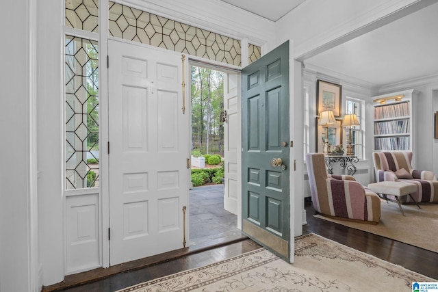 foyer featuring ornamental molding and dark wood finished floors