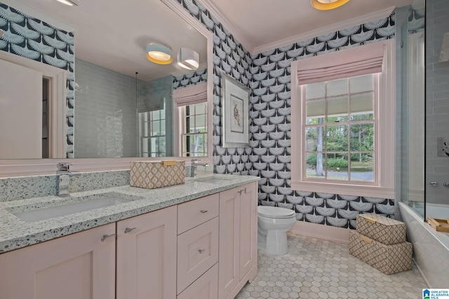 full bathroom featuring crown molding, toilet, a sink, and plenty of natural light