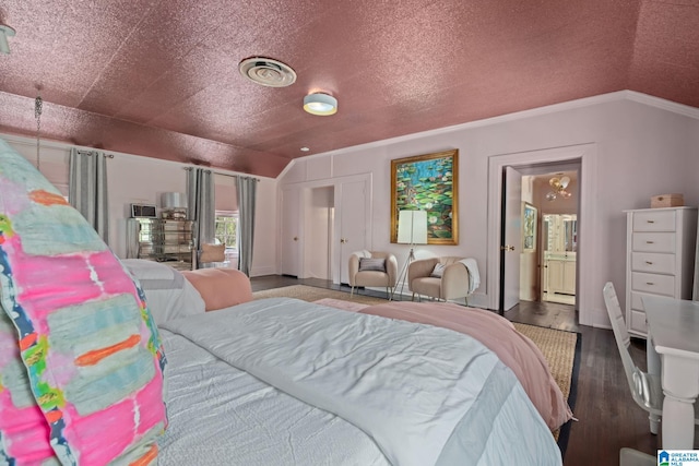 bedroom with visible vents, wood finished floors, ornamental molding, and vaulted ceiling
