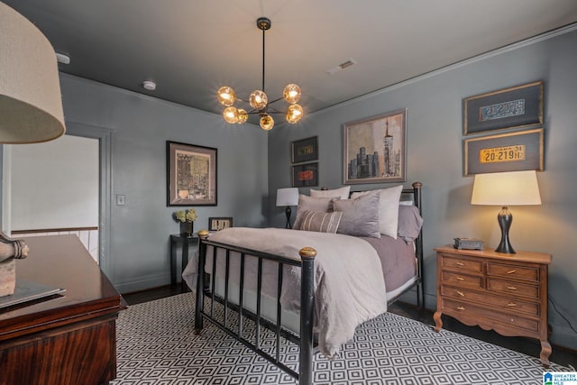 bedroom featuring wood finished floors, an inviting chandelier, ornamental molding, baseboards, and visible vents