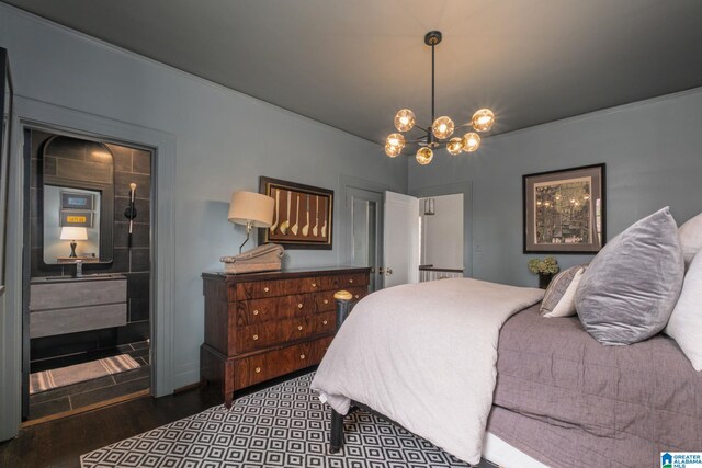 bedroom featuring wood finished floors, an inviting chandelier, and ornamental molding