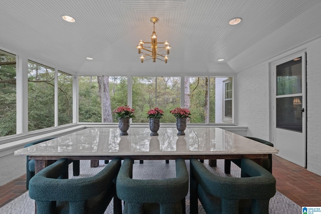 sunroom featuring a wealth of natural light and a notable chandelier