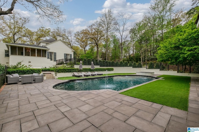 pool featuring an outdoor hangout area, fence, a lawn, and a patio area