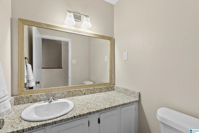 half bathroom with toilet and vanity