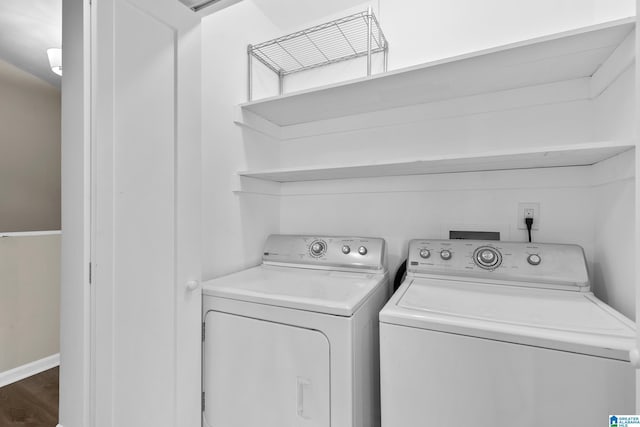 laundry area with independent washer and dryer, baseboards, laundry area, and dark wood finished floors