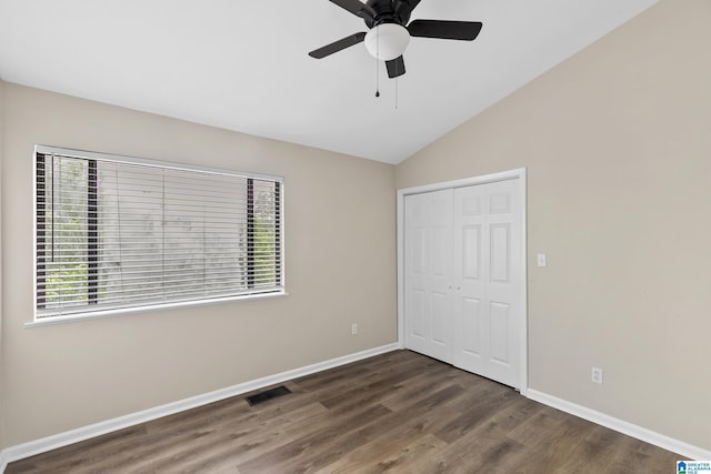 unfurnished bedroom with a closet, visible vents, wood finished floors, and baseboards
