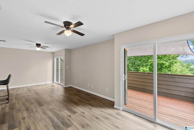 unfurnished living room featuring ceiling fan, wood finished floors, and plenty of natural light