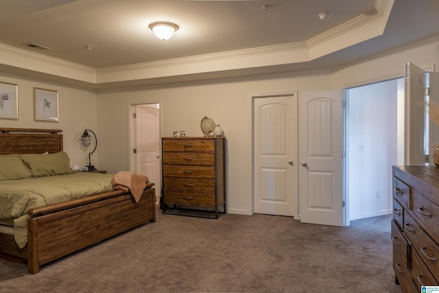 bedroom with crown molding, dark colored carpet, and a raised ceiling