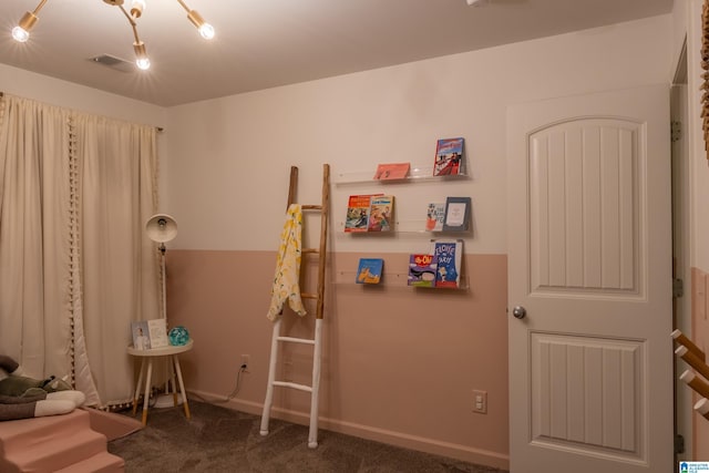 rec room featuring carpet flooring and baseboards