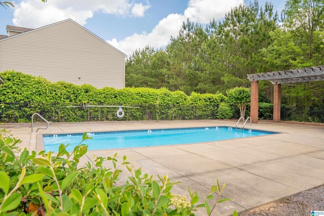 community pool featuring fence, a pergola, and a patio area