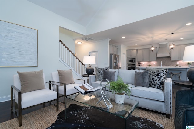 living room featuring wood finished floors, visible vents, recessed lighting, and stairs