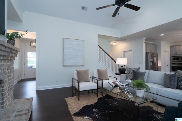 living area with baseboards, visible vents, a ceiling fan, and stairway