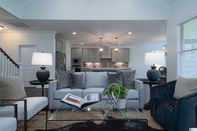 living room featuring visible vents, wood finished floors, crown molding, and recessed lighting