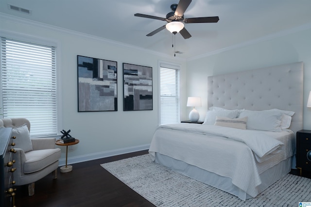 bedroom featuring crown molding, a ceiling fan, visible vents, baseboards, and wood finished floors