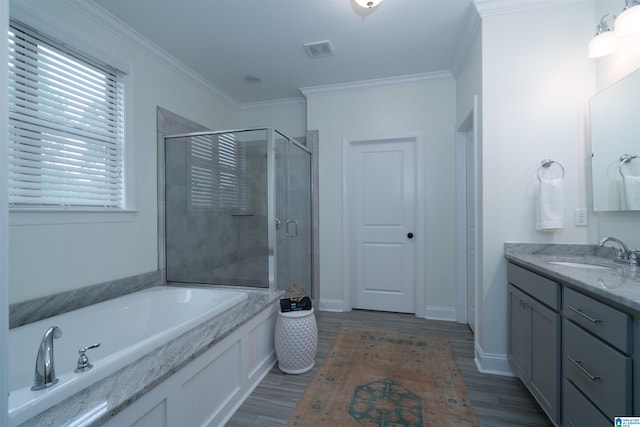 full bath featuring a shower stall, vanity, a bath, crown molding, and wood finished floors