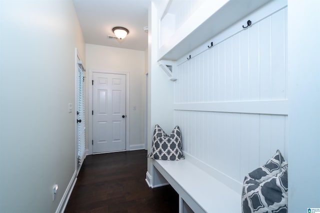 mudroom featuring baseboards, visible vents, and dark wood-type flooring