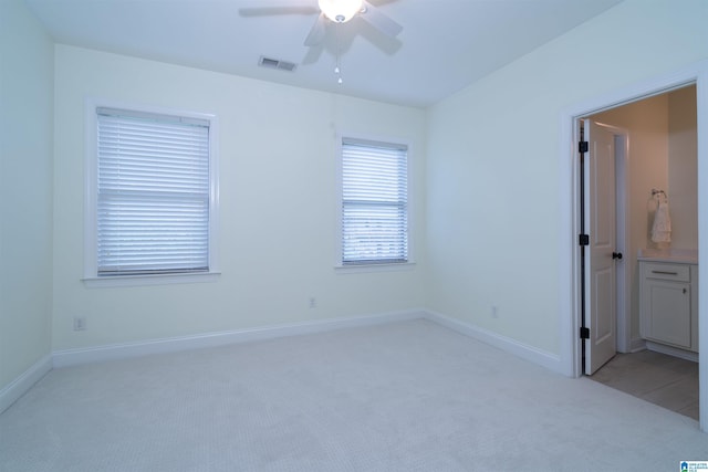unfurnished bedroom featuring light colored carpet, visible vents, and baseboards