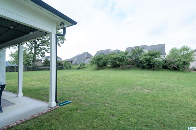 view of yard featuring fence and a patio area