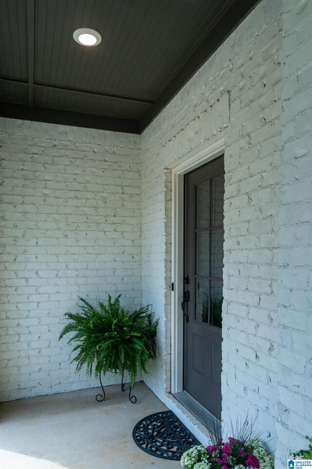 property entrance with brick siding