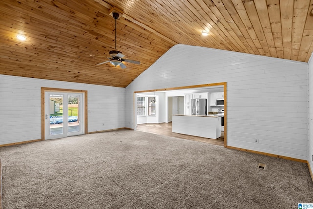 unfurnished living room featuring light carpet, baseboards, lofted ceiling, a ceiling fan, and wood ceiling