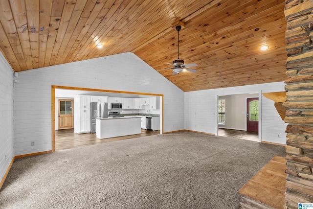 unfurnished living room featuring wood ceiling, dark carpet, and ceiling fan