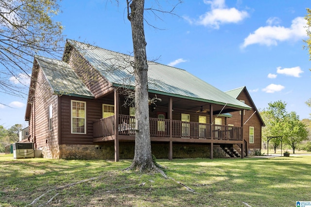 rear view of property featuring stairs, faux log siding, central AC unit, a yard, and ceiling fan