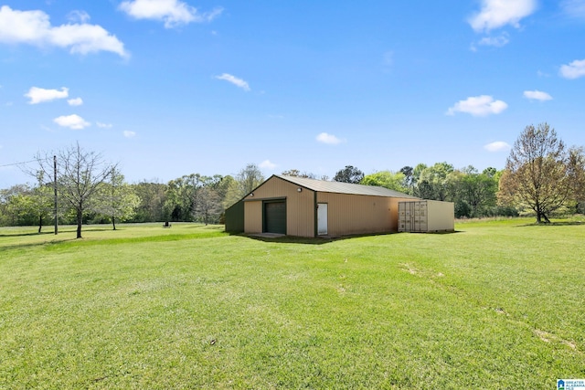 view of yard featuring an outbuilding and a detached garage
