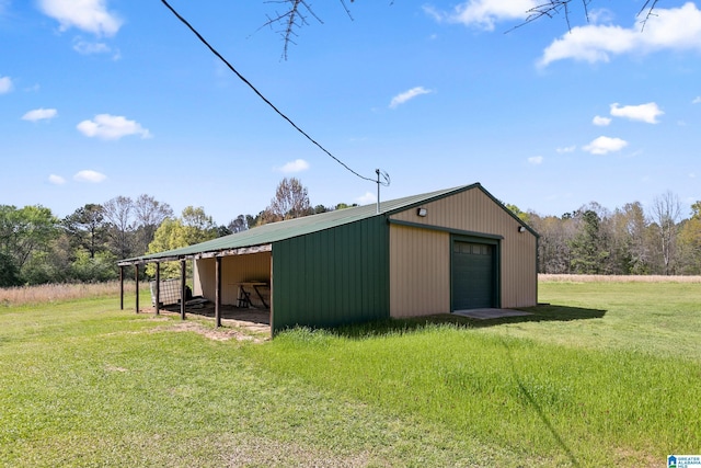 view of pole building with driveway and a yard