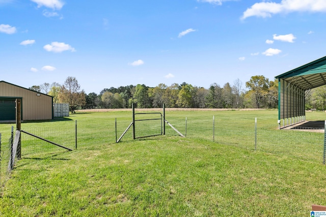 view of yard featuring fence, an outbuilding, and an outdoor structure