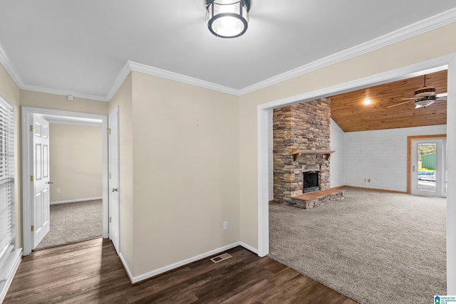 unfurnished living room featuring dark wood-style floors, baseboards, visible vents, ceiling fan, and a fireplace