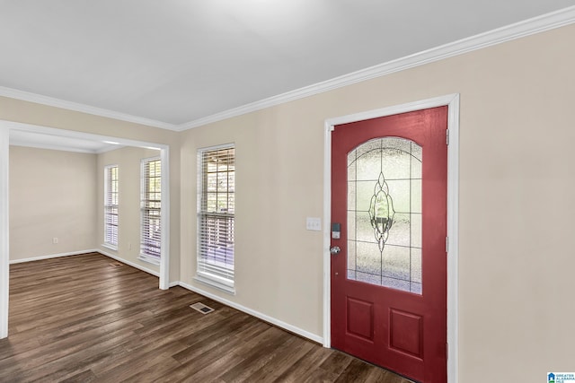 foyer with dark wood-type flooring, visible vents, crown molding, and baseboards