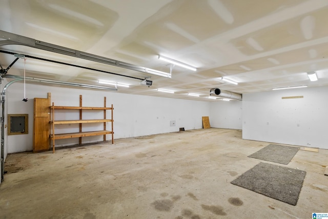 garage with electric panel and a garage door opener