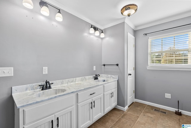 bathroom with baseboards, ornamental molding, a sink, and visible vents