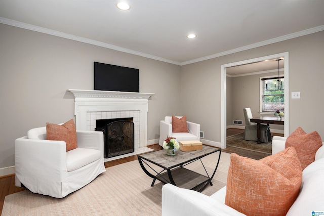 2005 Southwood Rd, Vestavia Hills, AL 35216 - living room with recessed lighting, a tiled fireplace, crown molding, baseboards, and wood finished floors