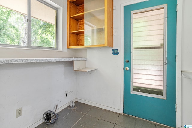 2725 Shades Crest Rd, Vestavia Hills, AL 35216 - laundry room with dark tile patterned floors and baseboards