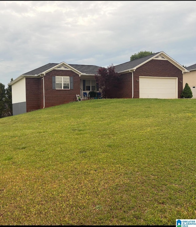 ranch-style house featuring brick siding, a garage, and a front yard