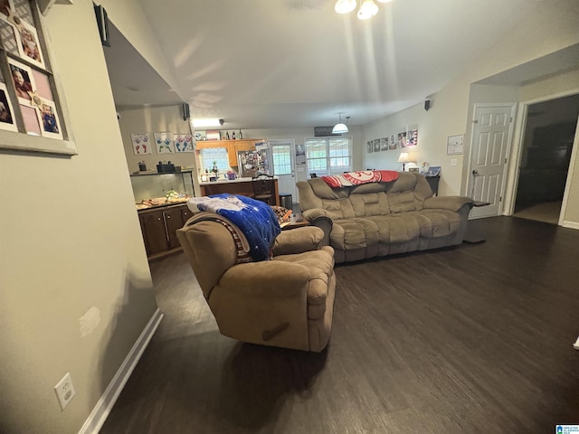 living area with baseboards and dark wood-type flooring