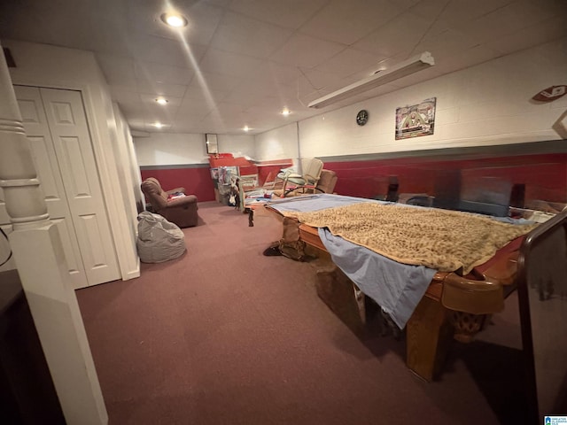playroom featuring concrete block wall, carpet floors, billiards, and a paneled ceiling