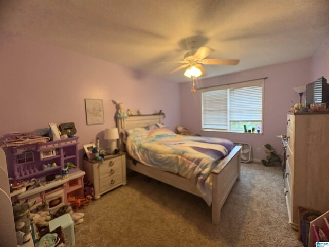 bedroom with a ceiling fan and carpet flooring