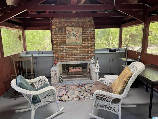 view of patio / terrace featuring a sink and an outdoor brick fireplace