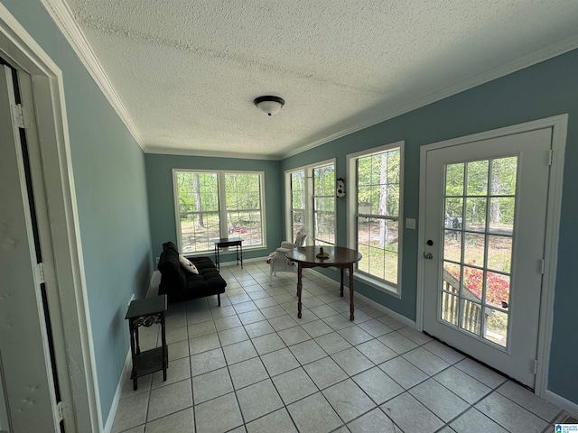 sunroom with crown molding, a textured ceiling, tile patterned floors, french doors, and baseboards