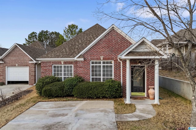 view of front of property featuring a shingled roof, brick siding, and a garage