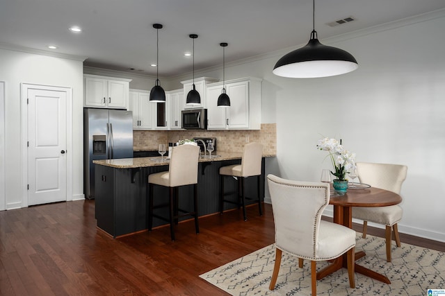 2385 Village Center St, Hoover, AL 35226 - kitchen with dark wood finished floors, white cabinetry, light stone countertops, appliances with stainless steel finishes, and decorative backsplash