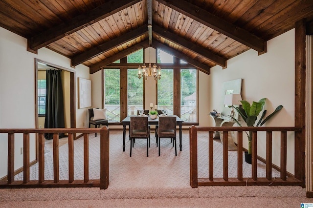 dining area featuring lofted ceiling with beams, light carpet, a wealth of natural light, a chandelier, and wooden ceiling