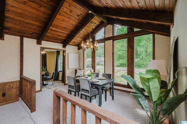 dining space with light colored carpet, wood ceiling, a notable chandelier, and vaulted ceiling with beams