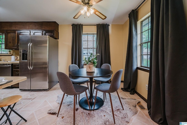 dining space with light tile patterned flooring, visible vents, and a ceiling fan