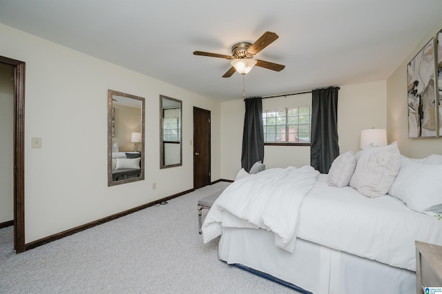 carpeted bedroom featuring a ceiling fan and baseboards