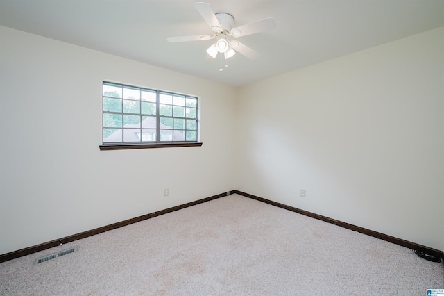 empty room featuring baseboards, a ceiling fan, visible vents, and carpet flooring