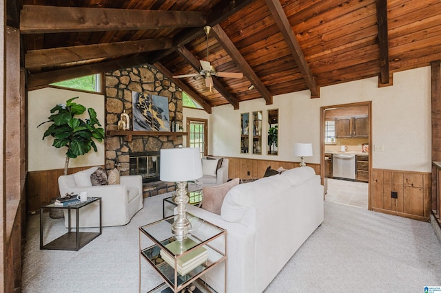 living room featuring a wainscoted wall, wood walls, a ceiling fan, beamed ceiling, and wood ceiling